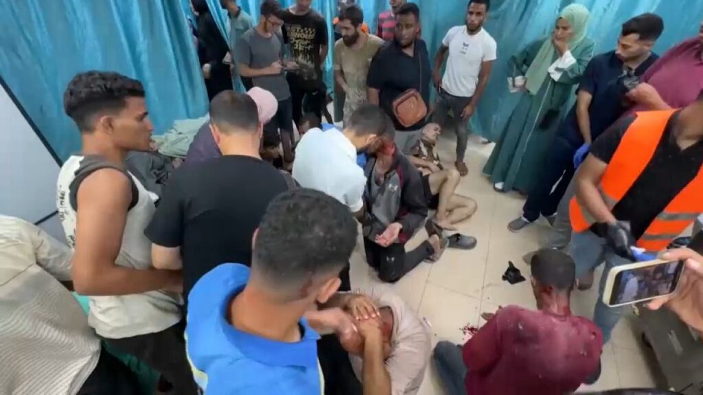 Patients are treated on the floor at Al-Aqsa Hospital in Gaza.