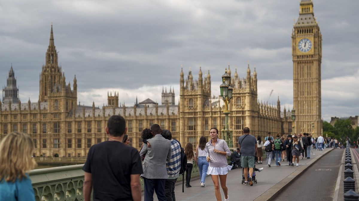 People walk on Westminster Bridge in London.