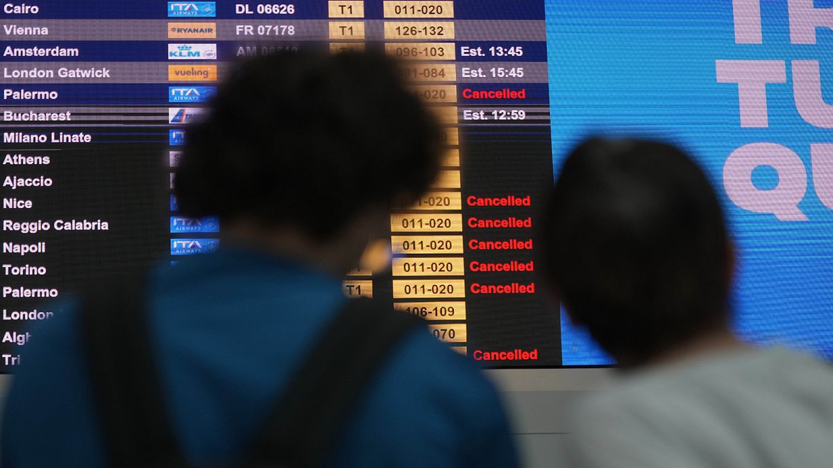 Passengers crowd the International flights departure terminal of Rome