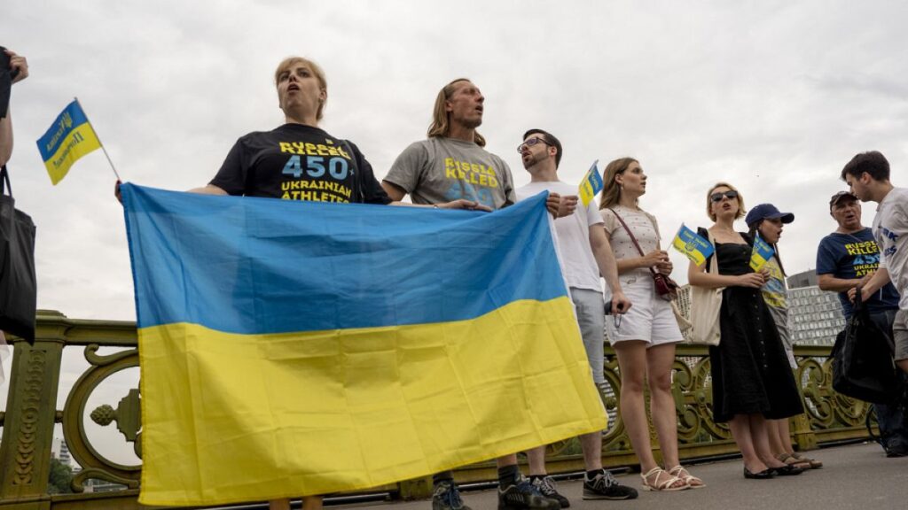 People attend a flash mob to highlight the plight of hundreds of Ukrainian athletes and coaches, both amateur and professional, who were killed as a result of Russia