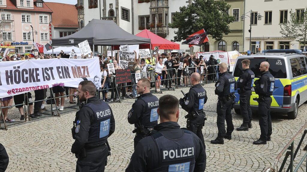 Left-wing demonstrators protest against the AfD Thuringia summer party and are held back by police officers, in Saalfeld, Germany, Saturday, July 27, 2024.