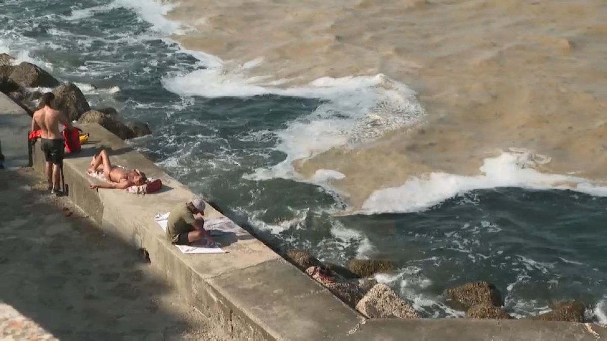 People sitting by the sea at Ancona