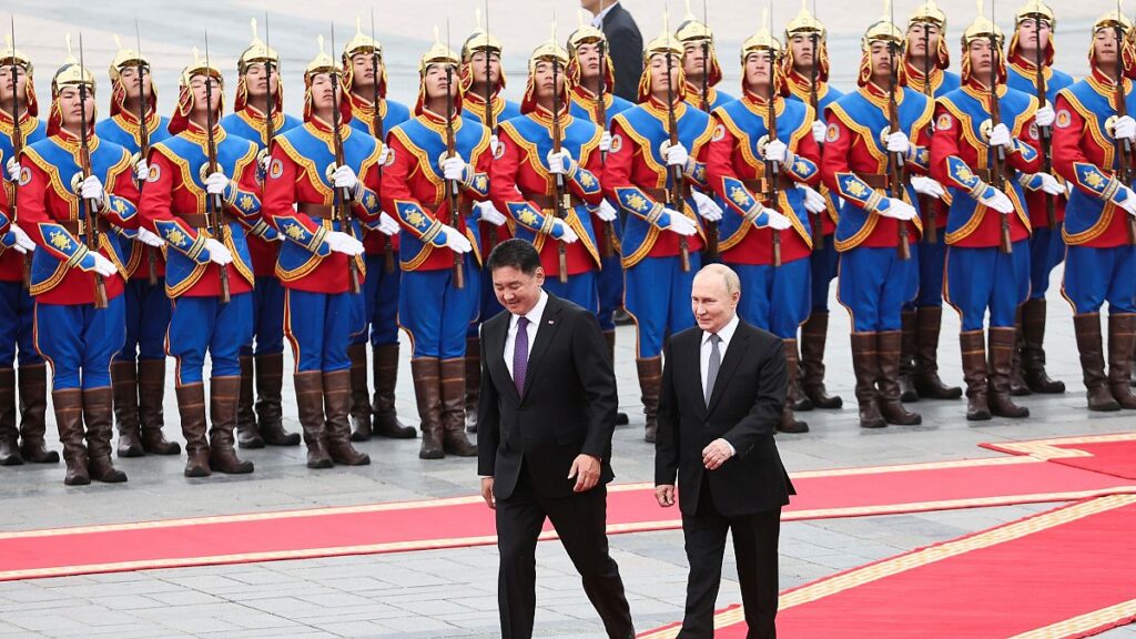 Russian President Vladimir Putin, right, walks with Mongolian President Ukhnaagiin Khurelsukh, left, during a welcoming ceremony at Sukhbaatar Square in Ulaan Bator, Mongolia.