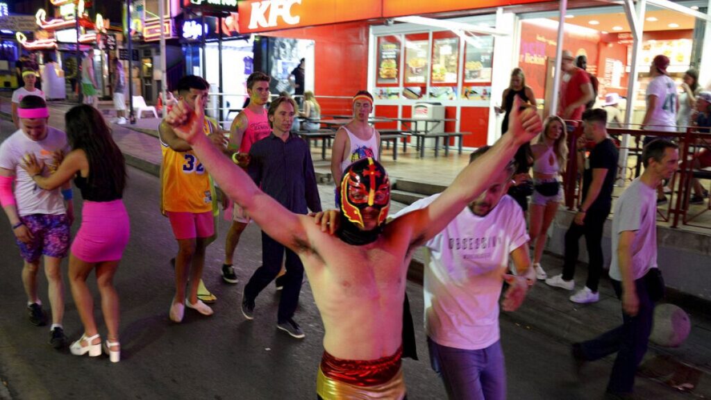 Is the party over? Young tourists walk on the street at in Magaluf on the Spanish Balearic island of Mallorca, Spain