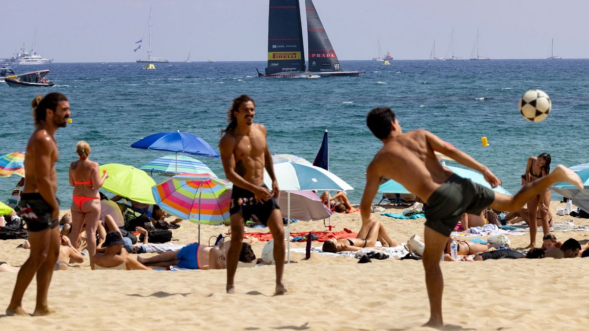 People play football on the beach in Barcelona, Spain, 24 August 2024.