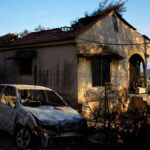 Damaged house and car, which had been burned in a mid-August wildfire, are seen in Halandri suburb in northern Athens, 25 August 2024.