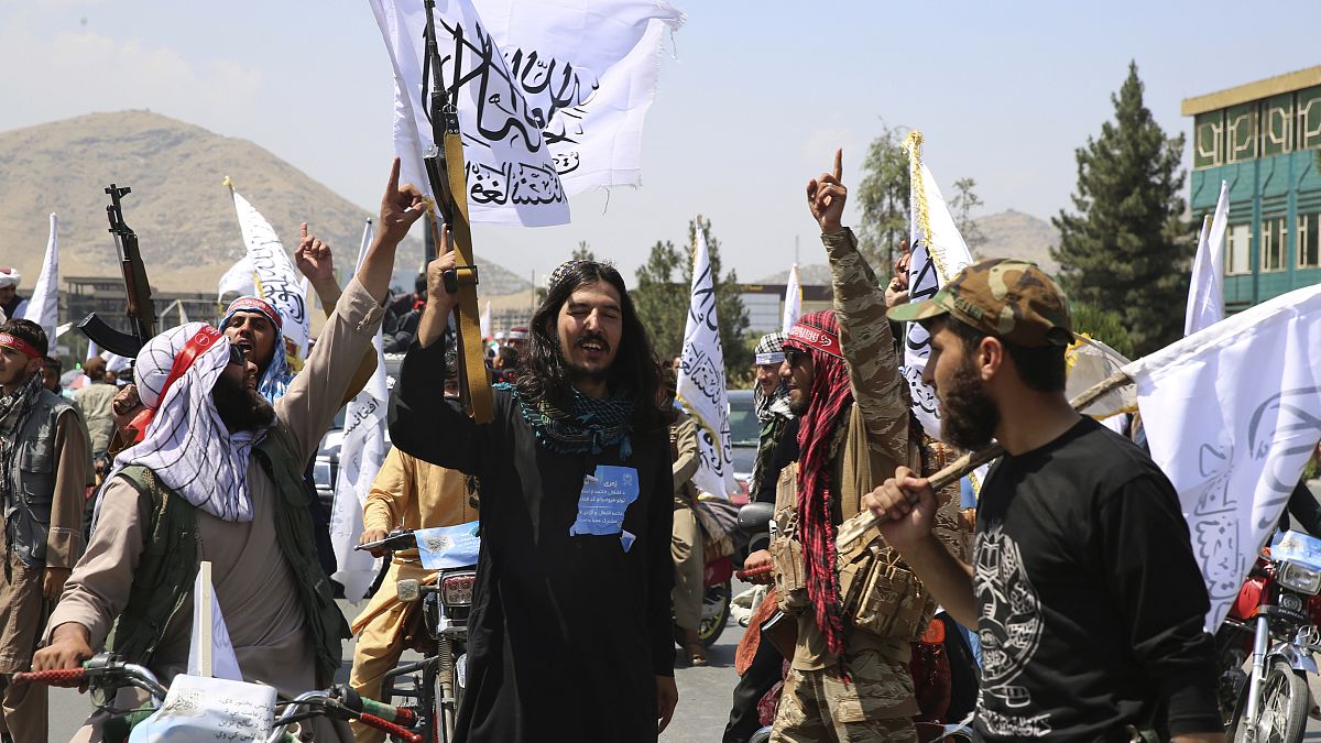 Taliban fighters celebrate the third anniversary of the withdrawal of US-led troops from Afghanistan, August 14, 2024