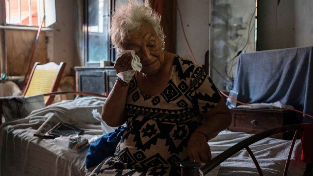 Margarita Salazar, 82, wipes the sweat off with a tissue inside her home in Veracruz, Mexico on June 16, 2024.