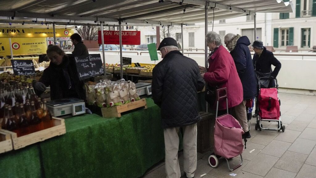 People shop at an open air market in Fontainebleau, south of Paris, France