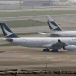 In this March 26, 2019 photo, Cathay Pacific Airways passenger aircrafts are parked at the Hong Kong International Airport.