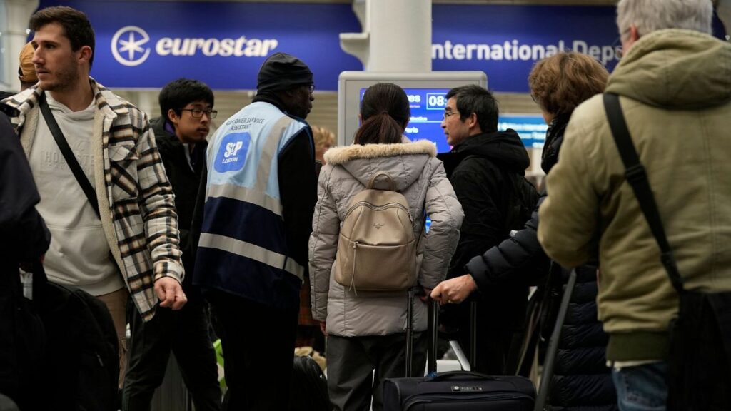 Travelers queue for the Eurostar trains at St Pancras Station in London, 22 December 2023.