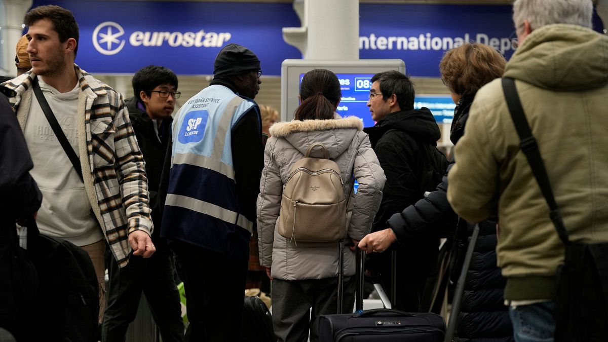 Travelers queue for the Eurostar trains at St Pancras Station in London, 22 December 2023.