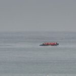 FILE - A boat thought to be with migrants is seen in the sea near the Wimereux beach, France, Wednesday, Sept. 4, 2024