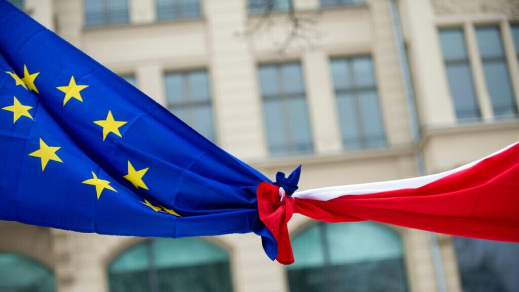 FILE PHOTO: Knotted EU, left, and Polish flags are photographed outside the Polish Institute in Berlin, Germany, Saturday Jan. 23, 2016