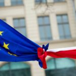 FILE PHOTO: Knotted EU, left, and Polish flags are photographed outside the Polish Institute in Berlin, Germany, Saturday Jan. 23, 2016