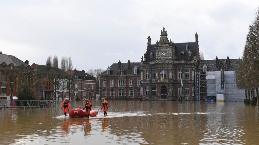 Rescue workers evacuate a person as the Aa river floods Arques, northern France, Thursday, 4 January , 2024.