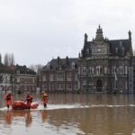 Rescue workers evacuate a person as the Aa river floods Arques, northern France, Thursday, 4 January , 2024.