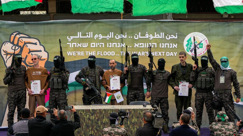 Israeli captives who have been held hostage in Gaza since 2023 are escorted by Hamas fighters before being handed over to the Red Cross in Deir al-Balah, 8 February, 2025