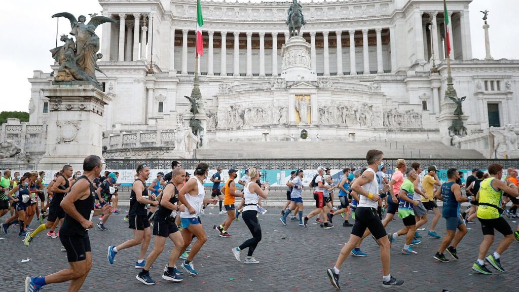 FILE: Participants run past the Monument of the Unknown Soldier during the Rome Marathon, in Rome, 19 September 2021