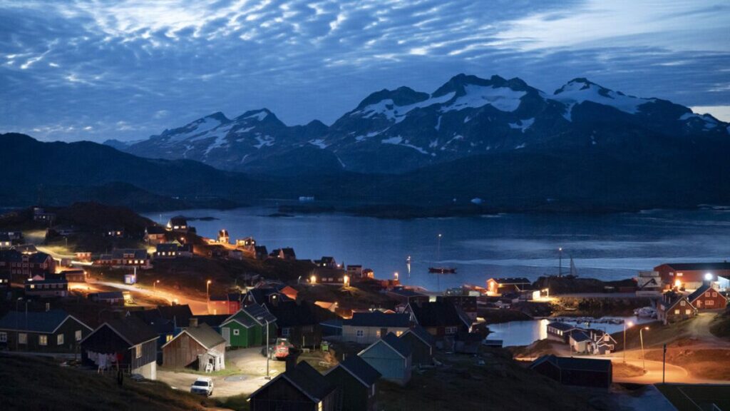 FILE PHOTO: Homes are illuminated after the sunset in Tasiilaq, Greenland, Friday Aug. 16, 2019.